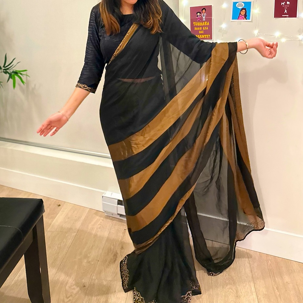 Black color saree just wore once . Brand new with stone golden embroidery.